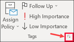 Red arrow pointing to the Message Options launcher in classic Outlook's Tags group.